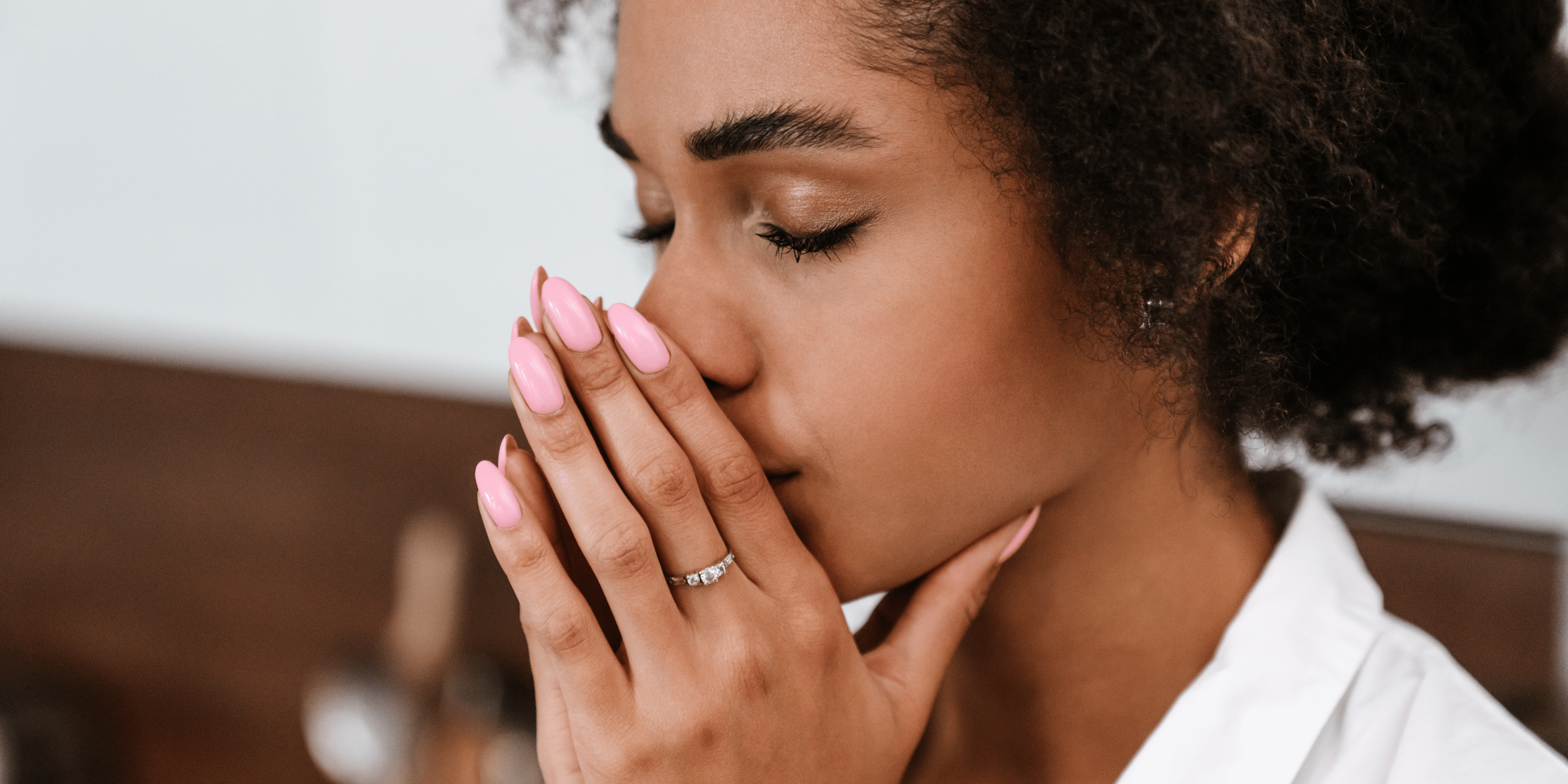 a young girl with her fingers holding her nose closed